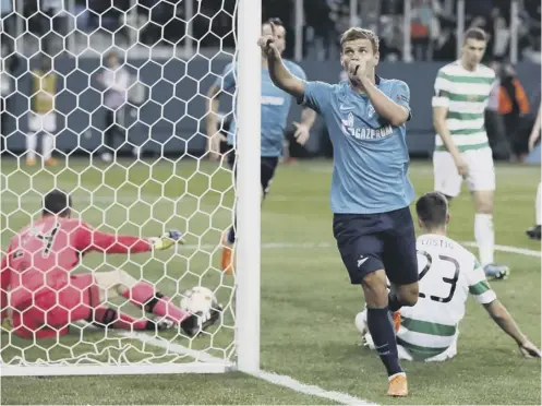  ??  ?? 0 Zenit’s Aleksandr Kokorin celebrates scoring his side’s third goal as Mikael Lustig and Celtic keeper Dorus De Vries are left stranded.