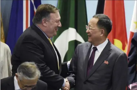 ?? JOSEPH NAIR — THE ASSOCIATED PRESS ?? Secretary of State Mike Pompeo, left, greets North Korea’s Foreign Minister Ri Yong-ho as they prepare Saturday for a group photo at the 25th ASEAN Regional Forum Retreat in Singapore. Pompeo stated that North Korea is far from living up to its...