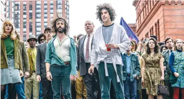  ?? ( Niko Tavernise/ Netflix) ?? SACHA BARON Cohen ( center right) as Abbie Hoffman in ‘ The Trial of the Chicago 7.’