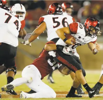  ?? Santiago Mejia / The Chronicle ?? Stanford linebacker Joey Alfieri sacks San Diego State’s Christian Chapman in the fourth quarter Friday. The Cardinal had five sacks in their season-opening 31-10 win.