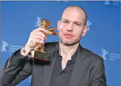 ?? CHRISTOPH SOEDER/DPA/AFP ?? Nadav Lapid poses with the Golden bear for best film for during the 69th Berlinale film festival.