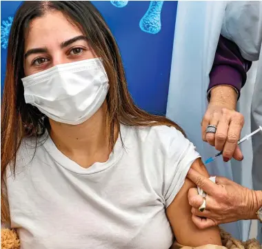  ?? ?? LIFESAVER: An Israeli teenager getting her Covid vaccine at a health clinic in Tel Aviv last week