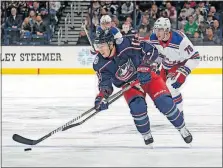  ?? [KYLE ROBERTSON/ DISPATCH] ?? Now securely under contract, Blue Jackets right wing Cam Atkinson carries the puck down ice ahead of Rangers defenseman Brady Skjei.