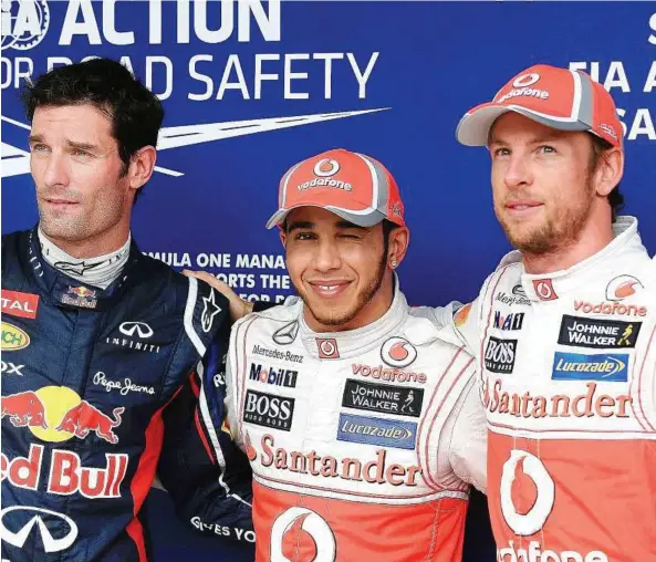  ??  ?? Top three: Lewis Hamilton (centre) smiling after taking pole position in the Brazilian Grand Prix at the Interlagos racetrack in Sao Paulo. Team-mate Jenson Button (right) is second on the grid and Mark Webber third. — EPA