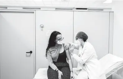  ?? ALESSANDRO GRASSANI/THE NEW YORK TIMES ?? A woman receives a vaccine for COVID-19 Dec. 27 at a hospital in Piacenza, Italy.