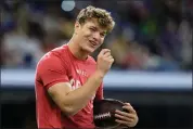  ?? CHARLIE REIDEL — THE ASSOCIATED PRESS ?? Michigan quarterbac­k J.J. McCarthy talks to a fellow player during the NFL football scouting combine, March 2, in Indianapol­is.