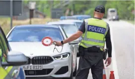  ?? SEAN GALLUP/GETTY IMAGES ?? Police monitor cars on a road not far from the venue of the upcoming G-7 summit near Mittenwald, Germany.