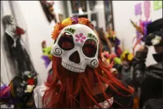  ?? DANIEL BRENNER — SPECIAL TO THE DENVER POST ?? A woman celebrates at a Dia de los Muertos block party during First Friday Art Walk on Nov. 1, 2019, at CHAC Gallery in the Art District on Santa Fe.