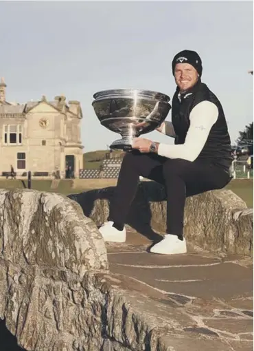  ?? ?? 0 Danny Willett poses with the trophy on the famous Swilcan Bridge at St Andrews