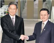  ?? AFP ?? Wang Yu-chi, right, shakes hands with Chinese official Zhang Zhijun, director of the Taiwan Affairs Office, at a hotel in Taoyuan on June 25 last year.