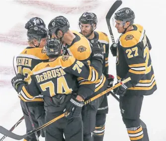  ?? NICOLAUS CZARNECKI / BOSTON HERALD ?? ALL TOGETHER: The Bruins celebrate a goal during their win over the Flyers.