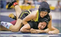  ?? Morgan Timms/The Taos News ?? Tierra Encantada’s Ida Contreras pins Valley’s Brianna Garcia in a 131-pound exhibition match during the 2019 NMAA State Wrestling Tournament at the Santa Ana Star Center in Río Rancho (Feb. 23). Next year, in 2020, girls will have a division and medals of their own.