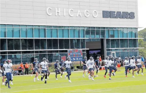  ?? JOSE M. OSORIO/CHICAGO TRIBUNE ?? Chicago Bears players warm up during training camp at Halas Hall in Lake Forest on Aug. 10.