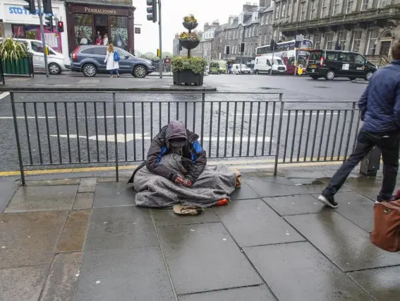  ?? (Getty) ?? A beggar in Edinburgh city centre. Most local authoritie­s discourage people from giving money to those on the street, and instead advise donating to homeless charities