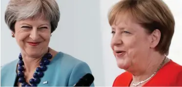  ??  ?? Concession­s on both sides: Theresa May and German Chancellor Angela Merkel