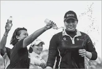  ?? BUTCH DILL/AP PHOTO ?? Ariya Jutanugarn is doused with water by friends and family after winning the U.S. Women’s Open on Sunday at Shoal Creek in Birmingham, Ala.