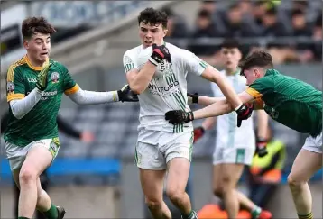  ??  ?? Rory O’Connor is closed down by St. Brendan’s duo Lorcan McMonagle and Jack Griffin.