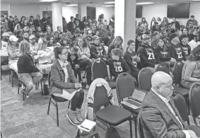  ?? MURRAY EVANS/THE OKLAHOMAN ?? Moore Public Schools board members faced a room overflowin­g with supporters of fired Westmoore football coach Lorenzo Williams on Monday night, listening to appeals to reinstate the coach who was dismissed just three days after being named as the District 6AI-1 coach of the year by his peers.