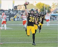  ?? CATHIE COWARD THE HAMILTON SPECTATOR ?? Kitchener native Mike Daly initially threw the ball into the stands after scoring his first CFL touchdown, but a Twitter appeal led to him getting it back through a memorabili­a exchange with a fan.