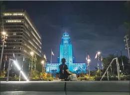  ?? Gina Ferazzi Los Angeles Times ?? L.A. CITY HALL is lighted in Dodger blue to honor Vin Scully. “To have Vinny on was like, ‘OK, maybe things are going to be all right,’ ” one fan said.