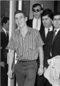  ??  ?? Stiff and limping: Brian Robson on his arrival back at Heathrow in 1965