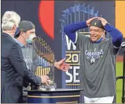  ?? AP - Tony Gutierrez ?? Dodgers manager Dave Roberts celebrates with the trophy after defeating the Rays to win the World Series on Tuesday.