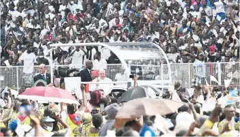  ?? — AFP photo ?? Pope Francis (centre) waves as he arrives by popemobile for a meeting with young people and catechists at Martyrs’ Stadium in Kinshasa, Democratic Republic of Congo (DRC).