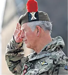  ??  ?? The Prince of Wales takes a salute before presenting the medals to 3 SCOTS soldiers