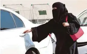  ?? AFP PIC ?? A Saudi woman getting into a taxi in Riyadh. Women will not need permission from their male guardians to get a licence, and would be allowed to drive anywhere.