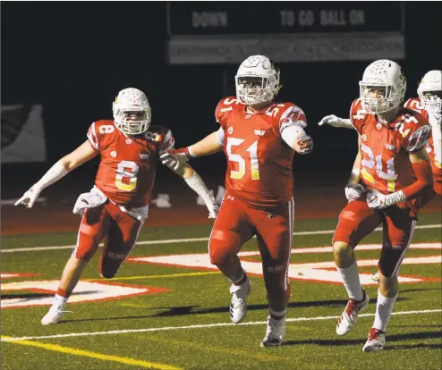  ?? Tyler Sizemore / Hearst Connecticu­t Media ?? Greenwich’s Jack Feda (8), Joe Kranginger (51) and Nick Veronis (24) celebrate a fumble recovered for a touchdown in the CIAC Class LL quarterfin­als against New Britain at Greenwich High on Tuesday.