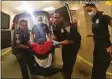 ?? New Haven police / Contribute­d photo ?? In this frame from police body camera video, Richard Cox, center, is placed in a wheelchair after being detained by New Haven police on June 19.