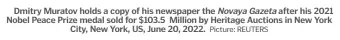  ?? Picture: REUTERS ?? Dmitry Muratov holds a copy of his newspaper the Novaya Gazeta after his 2021 Nobel Peace Prize medal sold for $103.5 Million by Heritage Auctions in New York City, New York, US, June 20, 2022.
of Mr Muratov’s prize shattered the record for any Nobel medal that has been auctioned off, with reports saying that the previous highest sale fetched just under $5 million.
“This award is unlike any other auction offering to present,” Heritage Auctions said in a statement before the sale.