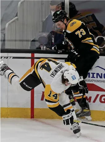  ?? MATT STONE / HErALD STAFF FILE ?? STANDING UP: Bruins defenseman Charlie McAvoy knocks down Penguins forward Mark Jankowski during an April 1 game.