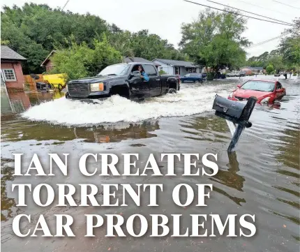  ?? ALEX BRANDON/AP ?? A car drives through high water after Hurricane Ian hit Charleston, S.C., in late September.