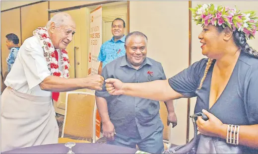  ?? Picture: JONACANI LALAKOBAU ?? UNAIDS goodwill ambassador for HIV in the Pacific and Speaker of Parliament Ratu Epeli Nailatikau (left) shares a light moment and a fist bump with Jokapeci Tuberi Cati during the World AIDS Day celebratio­n at the Holiday Inn in Suva yesterday.