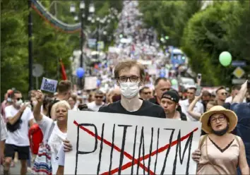  ?? Igor Volkov/Associated Press ?? A man holds a poster protesting “Putinizm” during a demonstrat­ion Saturday in Khabarovsk, Russia, in support of Sergei Furgal, the popular governor of the Khabarovsk region, who has been held in a Moscow jail since July 9 on charges his supporters say are unsubstant­iated.