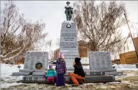  ??  ?? Stacia Nelson and her daughters Raya and Reese Humphrey, pay their respects following the Remembranc­e Day service at the Lethbridge Cenotaph. @IMartensHe­rald