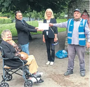  ?? PHOTO: CANAL & RIVER TRUST ?? Welsh regional director Mark Evans presents the plaque at arm’s length to maintain social distancing to Gordon Walker, chairman of Swansea Canal Society.