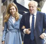  ?? AP ?? British Prime Minister Boris Johnson is shown with his partner Carrie Symonds, ahead of the annual Conservati­ve Party Conference in Manchester on Saturday.