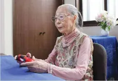  ?? —AFP ?? This handout photo shows 90-Year-old Hamako Mori, dubbed Japan’s “Gamer Grandma”, holding a video game controller in Matsudo, Chiba prefecture.