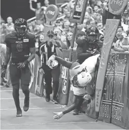  ??  ?? Sioux Falls Storm receiver Kent Shelby (bottom right) dives off the pads vs. the Rattlers in the second half of the United Bowl on Saturday at Gila River Arena.