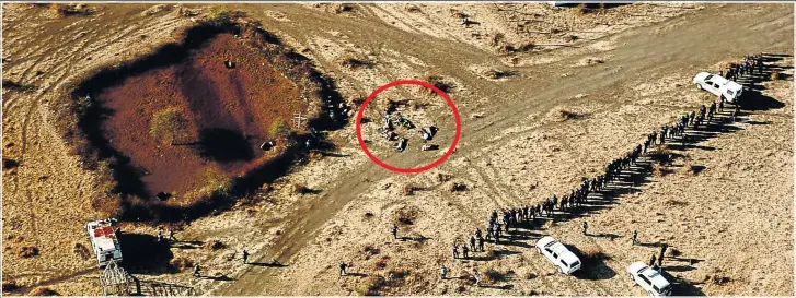  ?? Picture: SAPS ?? PLACE OF KILLING: In this picture, which has never been seen before, the police are seen advancing on the dead miners