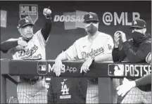  ?? RONALD MARTINEZ/GETTY ?? Dodgers manager Dave Roberts, left, on his team’s offensive versatilit­y in the postseason: “We have to understand what we can do that night.”