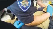  ??  ?? BODY CAMERA FOOTAGE shows officers pinning Gonzalez to the ground using their body weight.