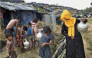  ??  ?? Rough living:
Rohingya collecting water from a tube well that was installed a few days ago at a new refugee camp at Cox’s Bazar in Ukhiya, Bangladesh. — AP