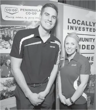  ??  ?? Nick Babich and Coleen Sparrow, representa­tives of Peninsula Co-op, one of 44 local businesses whose goods and services were showcased at Greater Victoria Chamber of Commerce’s Marketplac­e Mixer, its biggest ever.