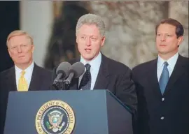  ?? George Bridges AFP/Getty Images ?? PRESIDENT CLINTON, with House Minority Leader Richard Gephardt and Vice President Al Gore, speaks after the House impeached him on Dec. 19, 1998.