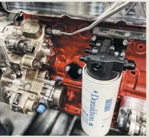  ??  ?? pthanks to its simple design and the weight savings it will provide competitor­s, S&S Diesel Motorsport’s new Cp3-coupled lift pump should prove to be a major breakthrou­gh for high-end common-rail engines. Capable of flowing 3,000-lph, its gear-driven pump will have no problem supporting as many CP3’S as you want to run. Here, S&S’S pump is shown as part of its fuel delivery system bolted to one of Wagler’s Streetfigh­ter series Cummins engines. In addition to the fuel pump, S&S’S soon-to-be-released kit features a filter head that can feed up to three CP3’S and that utilizes a Donaldson filter.