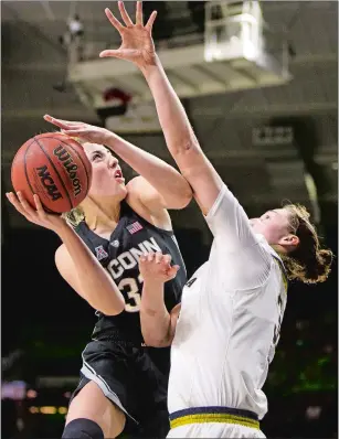  ?? ROBERT FRANKLIN/AP PHOTO ?? UConn’s Katie Lou Samuelson, left, goes up for a shot with pressure from Notre Dame’s Jessica Shepard during the first half of Sunday’s game at South Bend, Ind.