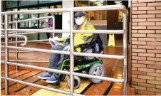  ?? — AFP photo ?? Photo shows Yan riding his wheelchair to the bus station on his way to buy face masks in Hong Kong.